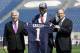 New England Patriots first-round draft choice Dominique Easley, center, displays a football jersey with Patriots Chairman and CEO Robert Kraft, left, and President Jonathan Kraft, right, Monday, May 12, 2014, at Gillette Stadium, in Foxborough, Mass. (AP Photo/Steven Senne)