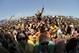 In this image taken with a fisheye lens, fans react as they watch Wiz Khalifa perform in the infield before the 137th Preakness Stakes horse race at Pimlico Race Course, Saturday, May 19, 2012, in Baltimore. (AP Photo/Nick Wass)