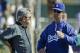 Los Angeles Dodgers manager Don Mattingly talks to general manager Ned Colletti during a spring training baseball workout Wednesday, Feb. 23, 2011, in Glendale, Ariz. (AP Photo/Morry Gash)
