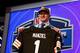 NEW YORK, NY - MAY 08: Johnny Manziel of the Texas A&M Aggies poses with a jersey after he was picked #22 overall by the Cleveland Browns during the first round of the 2014 NFL Draft at Radio City Music Hall on May 8, 2014 in New York City. (Photo by Elsa/Getty Images)