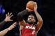 Miami Heat forward LeBron James (6) shoots a three-pointer in the second half of Game 4 of a second-round NBA playoff basketball game against the Brooklyn Nets at the Barclays Center, Monday, May 12, 2014, in New York. James tied his playoff career high with 49 points as the Heat defeated the Nets 102-96 to go ahead 3-1 in the best of seven series. (AP Photo)