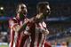 Atletico's Adrian Lopez, right, celebrates after scoring his sides first goal during the Champions League semifinal second leg soccer match between Chelsea and Atletico Madrid at Stamford Bridge stadium in London, Wednesday, April 30, 2014. (AP Photo/Matt Dunham)