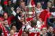 Arsenal captain Patrick Vieira shows the trophy to jubilant fans after winning the FA Cup Final at the Millennium Stadium in Cardiff, Wales, Saturday, May. 21, 2005. Arsenal beat Man United 5-4 on penalties following a 0-0 draw after extra time. (AP Photo/Alastair Grant)