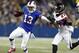 FILE - In this Dec. 1, 2013, file photo, Buffalo Bills wide receiver Stevie Johnson (13) pushes off Atlanta Falcons cornerback Robert McClain (27) during the first half of an NFL football game in Toronto. The Bills traded Johnson to the San Francisco 49ers on Friday, May 9, 2014, in a deal made before the start of the second round of the NFL draft. (AP Photo/Gary Wiepert, File)