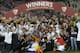 Sevilla players celebrate with the Europa League trophy after wining the Europa League soccer final between Sevilla and Benfica, at the Turin Juventus stadium, in Turin, Italy, Wednesday, May 14, 2014. (AP Photo/Andrew Medichini)