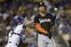 Miami Marlins' Giancarlo Stanton, right, reacts after he struck out during the eighth inning of a baseball game against the Los Angeles Dodgers on Tuesday, May 13, 2014, in Los Angeles. (AP Photo)