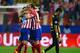 MADRID, SPAIN - APRIL 09: A dejected Neymar of Barcelona walks off the pitch as Gabi of Club Atletico de Madrid celebrates with team mates during the UEFA Champions League Quarter Final second leg match between Club Atletico de Madrid and FC Barcelona at Vicente Calderon Stadium on April 9, 2014 in Madrid, Spain. (Photo by Laurence Griffiths/Getty Images)