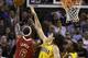 Miami Heat's LeBron James (6) shoots as Indiana Pacers' Luis Scola (4) and Ian Mahinmi (28) defend in the first half of an NBA basketball game, Wednesday, Dec. 18, 2013, in Miami. (AP Photo/Lynne Sladky)
