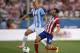 Atletico's Juanfran, right, vies for the ball with Malaga's Bartlomiej Pawlowsk during their Spanish La Liga soccer match at the Vicente Calderon stadium in Madrid, Spain, Sunday May 11, 2014. (AP Photo/Gabriel Pecot)