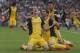 Atletico's Diego Godin from Uruguay, left, celebrates with teammates after scoring his side's first goal during a Spanish La Liga soccer match between FC Barcelona and Atletico Madrid at the Camp Nou stadium in Barcelona, Spain, Saturday, May 17, 2014. (AP Photo/Andres Kudacki)