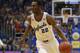 Kansas guard Andrew Wiggins (22) celebrates a three-point basket during the second half of an NCAA college basketball game against Oklahoma in Lawrence, Kan., Monday, Feb. 24, 2014. Wiggins scored 15 points in the game. Kansas defeated Oklahoma 83-75. (AP Photo/Orlin Wagner)