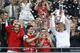 Arsenal's coach Arsene Wenger, right, hold the trophy aloft as he celebrates after his team won the English FA Cup final soccer match between Arsenal and Hull City at Wembley Stadium in London, Saturday, May 17, 2014. Arsenal won 3-2 after extra-time. (AP Photo/Kirsty Wigglesworth)