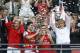 Arsenal's coach Arsene Wenger, right, hold the trophy aloft as he celebrates after his team won the English FA Cup final soccer match between Arsenal and Hull City at Wembley Stadium in London, Saturday, May 17, 2014. Arsenal won 3-2 after extra-time. (AP Photo/Kirsty Wigglesworth)