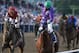 Jockey Victor Espinoza, center, aboard California Chrome, celebrates after winning the 139th Preakness Stakes horse race at Pimlico Race Course, Saturday, May 17, 2014, in Baltimore. Ride On Curlin, left, ridden by Joel Rosario, finished second. (AP Photo/Matt Slocum)