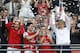 Arsenal's coach Arsene Wenger, right, hold the trophy aloft as he celebrates after his team won the English FA Cup final soccer match between Arsenal and Hull City at Wembley Stadium in London, Saturday, May 17, 2014. Arsenal won 3-2 after extra-time. (AP Photo/Kirsty Wigglesworth)