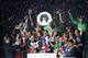 Paris Saint Germain's Brazilian defender Thiago Silva holds his trophy with teamates as he celebrates PSG's French League One title, at the Parc des Princes Stadium, in Paris, Saturday, May. 17, 2014.Paris Saint-Germain won the French League One Championship title on Saturday, the 4th in the club's history.(AP Photo/Jacques Brinon)