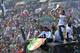 Juventus' players stand on a bus parading in downtown Turin, Italy, as they celebrate at the end of a Serie A soccer match between Juventus and Cagliari, Sunday, May 18, 2014. Juventus celebrated its third straight Serie A title with a 3-0 home victory over Cagliari to set a new European record of 102 points. Antonio Conte's side had already broken the Serie A points record but ensured it moved into triple figures by also becoming the first Italian side to maintain a 100% home record. (AP Photo/Massimo Pinca)