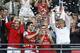 Arsenal's coach Arsene Wenger, right, hold the trophy aloft as he celebrates after his team won the English FA Cup final soccer match between Arsenal and Hull City at Wembley Stadium in London, Saturday, May 17, 2014. Arsenal won 3-2 after extra-time. (AP Photo/Kirsty Wigglesworth)