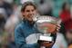 Spain's Rafael Nadal bites the trophy after winning against compatriot David Ferrer in three sets 6-3, 6-2, 6-3, in the final of the French Open tennis tournament, at Roland Garros stadium in Paris, Sunday June 9, 2013. (AP Photo/Christophe Ena)