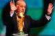 COSTA DO SAUIPE, BRAZIL - DECEMBER 06: Spain coach Vicente del Bosque places the World Cup trophy on a plinth on stage before the Final Draw for the 2014 FIFA World Cup Brazil at Costa do Sauipe Resort on December 6, 2013 in Costa do Sauipe, Bahia, Brazil. (Photo by Clive Mason/Getty Images)