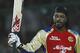 Chris Gayle of Royal Challengers Bangalore raises his bat after scoring a century during their IPL cricket match against Delhi Daredevils, in New Delhi, India, Thursday, May 17, 2012. (AP Photo/ Saurabh Das)
