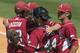 Arkansas players Zach Jackson, Alex Gosser, Trey Killian and Arkansas' Garrett Rucker celebrate after the team's 4-0 win over Texas A&M during the Southeastern Conference NCAA college baseball tournament Tuesday, May 20, 2014, in Hoover, Ala. (AP Photo/Hal Yeager)