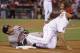 Houston Astros' George Springer, left, grimaces after being pickoff at first by Los Angeles Angels first baseman Albert Pujols during the ninth inning of a baseball game in Anaheim, Calif., Wednesday, May 21, 2014. Springer was injured by the play. (AP Photo/Chris Carlson)