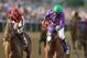 BALTIMORE, MD - MAY 17: California Chrome #3, ridden by Victor Espinoza, races accross the finishline to win the 139th running of the Preakness Stakes at Pimlico Race Course on May 17, 2014 in Baltimore, Maryland. (Photo by Matthew Stockman/Getty Images)