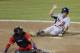 United States' Taylor Sparks (25) scores the go-ahead run against Cuba on a sacrifice fly by Kyle Schwarber, with Cuba catcher Lorenzo Quintana, bottom left, in the tenth inning of an exhibition baseball game in Papillion, Neb., Friday, July 19, 2013. United States won 3-2 in ten innings. (AP Photo/Nati Harnik)
