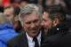 Real's coach Carlo Ancelotti, left, hugs Atletico's coach Diego Simeone from Argentina, right, during a Spanish La Liga soccer match between Atletico de Madrid and Real Madrid at the Vicente Calderon stadium in Madrid, Spain, Sunday, March 2, 2014. (AP Photo/Andres Kudacki)