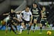 DERBY, ENGLAND - FEBRUARY 10: Craig Bryson of Derby County skips past Clint Hill and Richard Dunne of Queens Park Rangers during the Sky Bet Championship match between Derby County and Queens Park Rangers on February 10, 2014 in Derby, England. (Photo by Laurence Griffiths/Getty Images)