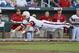 North Carolina State's Jake Armstrong leaps towards home plate before being tagged out by UCLA pitcher Nick Vander Tuig, following a single by Trea Turner in the third inning of an NCAA College World Series game in Omaha, Neb., Tuesday, June 18, 2013. (AP Photo/Ted Kirk)