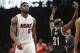 Miami Heat's LeBron James (6) walks toward the bench during a timeout in the first half of an NBA basketball game as Brooklyn Nets' Jason Terry (31) gestures to the crowd on Friday, Jan. 10, 2014, in New York. (AP Photo/Frank Franklin II)