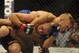 May 24, 2014; Las Vegas, NV, USA; Bantamweight Champion Renan Barao (red) struggles to break free of TJ Dillashaw's (blue) choke hold during their UFC 173 bantamweight championship bout at MGM Grand Garden Arena. Dillashaw won by way of TKO. Mandatory Credit: Stephen R. Sylvanie-USA TODAY Sports