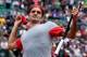 PARIS, FRANCE - MAY 25: Roger Federer of Switzerland throws his sweatband into the crowd as he celebrates victory in his men's singles match against Lukas Lacko of Slovakia on day one of the French Open at Roland Garros on May 25, 2014 in Paris, France. (Photo by Matthias Hangst/Getty Images)