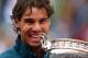 PARIS, FRANCE - JUNE 09: Rafael Nadal of Spain bites the Coupe des Mousquetaires trophy as he celebrates after the men's singles final against David Ferrer of Spain during day fifteen of the French Open at Roland Garros on June 9, 2013 in Paris, France. (Photo by Clive Brunskill/Getty Images)