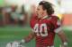 ADVANCE FOR WEEKEND EDITIONS, MAY 3-4 - FILE - In this Dec. 20, 1998, file photo, Arizona Cardinals safety Pat Tillman celebrates after tackling New Orleans Saints running back Lamar Smith for a loss in the third quarter of an NFL football game in Tempe, Ariz. Pat's Run is filled with inspirational stories all wanting to honor the memory of NFL star-turned-soldier . For seven years, Sheldon Davidson had become the annual exclamation point to the run, climbing out of his wheelchair and dragging the paralyzed left side of his body across the final 42 yards. He died 42 days before this year's run, so his wife and daughter made the journey without him, honoring two heroes with every step. (AP Photo/Roy Dabner, File)