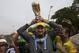 A Brazil soccer fan in the likeness of coach Luiz Felipe Scolari, wearing a fake nose, holds a replica of the FIFA World Cup trophy as he poses for photos with fans outside the venue where Brazil's coach announced his squad for the upcoming international soccer tournament in Rio de Janeiro, Brazil, Wednesday, May 7, 2014. The team will mix talented young stars such as Neymar and Oscar with more experienced players such as Dani Alves, David Luiz, Thiago Silva and Hulk. Past stars such as Ronaldinho, Kaka and Robinho were left off the squad as expected. (AP Photo/Silvia Izquierdo)