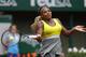 Serena Williams of the U.S, returns the ball to France's Alize Lim during the first round match of the French Open tennis tournament at the Roland Garros stadium, in Paris, France, Sunday, May 25, 2014. Williams won 6-2, 6-1. (AP Photo/Darko Vojinovic)