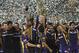 Players and support staff of Kolkata Knight Riders celebrate with the trophy after their win against Chennai Super Kings' in the Indian Premier League (IPL) final cricket match in Chennai, India, Sunday, May 27, 2012. Kolkata Knight Riders won the match by five wickets. (AP Photo/Aijaz Rahi)