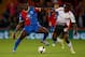 LONDON, ENGLAND - MAY 05: Yannick Bolasie of Crystal Palace and Victor Moses of Liverpool compete for the ball during the Barclays Premier League match between Crystal Palace and Liverpool at Selhurst Park on May 5, 2014 in London, England. (Photo by Clive Rose/Getty Images)