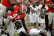 Georgia's Ray Drew, left, gets up after tackling Appalachian State quarterback Kameron Bryant, right, in the third quarter of an NCAA college football game, Saturday, Nov. 9, 2013, in Athens, Ga. (AP Photo/David Goldman)