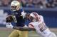 Notre Dame's DaVaris Daniels (10) stiff-arms Rutgers's Johnathan Aiken (26) during the second half of the Pinstripe Bowl NCAA college football game Saturday, Dec. 28, 2013, at Yankee Stadium in New York. Notre Dame won the game 29-16. (AP Photo/Frank Franklin II)