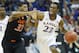 Kansas guard Andrew Wiggins (22) is covered by Oklahoma State guard Marcus Smart (33) during the second half of an NCAA college basketball game in the quarterfinals of the Big 12 Conference men's tournament in Kansas City, Mo., Thursday, March 13, 2014. Kansas defeated Oklahoma State 77-70 in overtime. (AP Photo/Orlin Wagner)