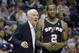 San Antonio Spurs coach Gregg Popovich, left, talks to Spurs' Kawhi Leonard (2) in the second half of an NBA basketball game in Memphis, Tenn., Tuesday, Jan. 7, 2014. The Spurs defeated the Grizzlies 110-108 in overtime. (AP Photo/Danny Johnston)