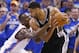 Oklahoma City Thunder forward Serge Ibaka (9) reaches in to try and take the ball away from San Antonio Spurs forward Tim Duncan (21) in the second quarter of Game 4 of the Western Conference finals NBA basketball playoff series in Oklahoma City, Tuesday, May 27, 2014. (AP Photo/Sue Ogrocki)