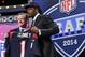 South Carolina defensive end Jadeveon Clowney holds up the jersey for the Houston Texans first pick of the first round of the 2014 NFL Draft with NFL commissioner Roger Goddell, Thursday, May 8, 2014, in New York. (AP Photo/Craig Ruttle)
