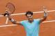 Spain's Rafael Nadal raises his arms after defeating Austria's Dominic Thiem during the second round match of the French Open tennis tournament at the Roland Garros stadium, in Paris, France, Thursday, May 29, 2014. Nadal won 6-2, 6-2, 6-3. (AP Photo/Darko Vojinovic)