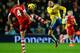 SOUTHAMPTON, ENGLAND - JANUARY 28: Morgan Schneiderlin of Southampton and Mesut Oezil of Arsenal compete for the ball during the Barclays Premier League match between Southampton and Arsenal at St Mary's Stadium on January 28, 2014 in Southampton, England. (Photo by Mike Hewitt/Getty Images)