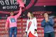 Colombia's Nairo Quintana is applauded by Formula One driver Fernando Alonso, right, as he celebrates on the podium after completing the 18th stage of the Giro d'Italia cycling race from Belluno to Rifugio Panarotta, Italy, Thursday, May 29, 2014. Julian Arredondo of Colombia claimed the biggest win of his career with a solo victory on the 18th stage of the Giro d'Italia on Thursday, while Nairo Quintana retained the overall leader's pink jersey as the race returned to the mountains. (AP Photo/Gian Mattia D'Alberto)